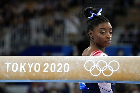 Simone Biles, of the United States, prepares to start her performance on the balance beam during the artistic gymnastics women's apparatus final at the 2020 Summer Olympics. (File Photo | AP)