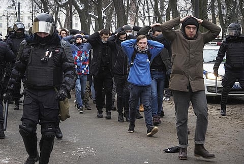 FILE - Detained protesters are escorted by police during a protest against the jailing of opposition leader Alexei Navalny in St. Petersburg, Russia, on Jan. 31, 2021. (Photo | AP)