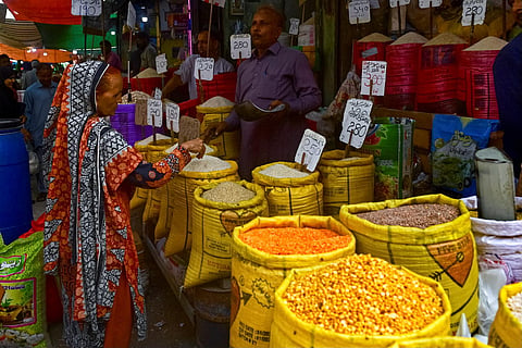 A customer buys rice at a wholesale shop in Karachi on June 8, 2023. (Photo | AFP)