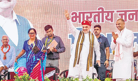 Amit Shah with Rajasthan BJP president CP Joshi and former Rajasthan chief minister Vasundhara Raje at a rally in Udaipur on Friday  | pti
