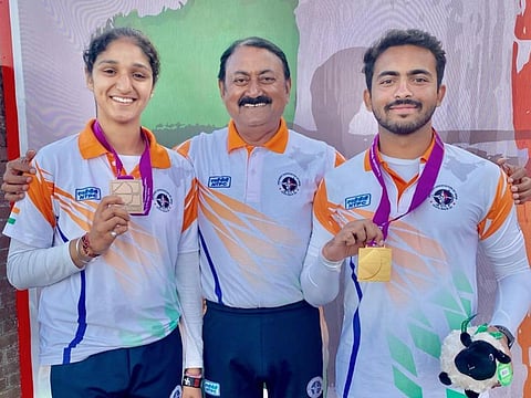 Under-21 bronze medal winner Bhajan Kaur (left) and Under-21 world champion Parth Salunkhe with Indian high-performance director Sanjeeva Singh (middle) on July 10, 2023. (PTI)