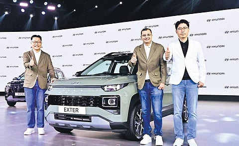 (L-R) Unsoo Kim, MD & CEO, Hyundai Motor India; Tarun Garg, COO;  J T Park, executive director (sales, marketing & service), at the launch of Hyundai Exter in New Delhi.