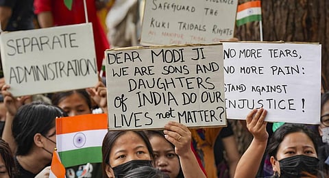 Image of people belonging to the Kuki tribe protest against the killing of tribals in violence-hit Manipur, in New Delhi. (File photo | PTI)