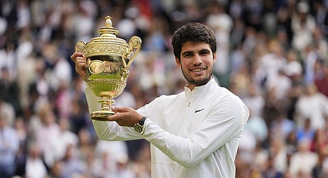 Spain's Carlos Alcaraz celebrates with the trophy after beating Serbia's Novak Djokovic to win the final of the men's singles Wimbledon tennis championships in London, July 16, 2023 (Photo | AP)