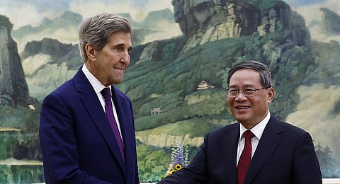 US Special Presidential Envoy for Climate John Kerry, left, and Chinese Premier Li Qiang shake hands before a meeting at the Great Hall of the People in Beijing Tuesday, July 18, 2023. (Photo | AP)