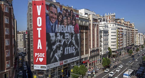 A poster depicting Spain's PM Pedro Sánchez and conservative PP party leader Alberto  Feijóo and far-right VOX party leader Santiago Abascal is displayed on a building in Madrid. (Photo | AP)