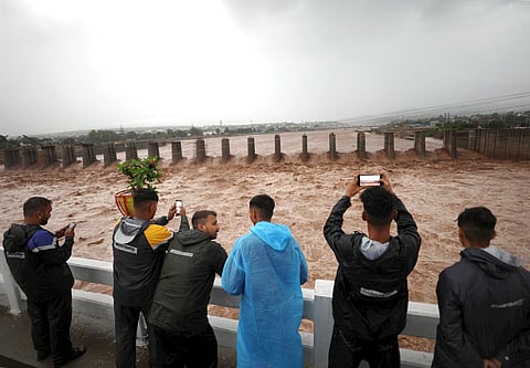 FILE: People watch the swollen Tawi river in Jammu.(Photo|PTI)