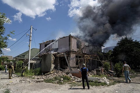 Ukrainian State Emergency Service firefighters put out a fire at a house destroyed in a Russian shelling, in a residential neighbourhood, in Kherson, Ukraine. (Photo | AP)