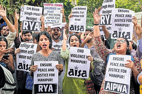 Members of various organisations stage a protest against the ongoing ethnic violence in Manipur on Friday | PTI