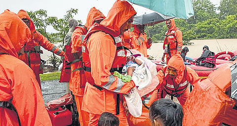 Representational Image: NDRF personnel carry an infant during a rescue operation for people stuck in flood-hit village in Poladpur, Raigad in Maharashtra on Wednesday. (Photo | PTI)