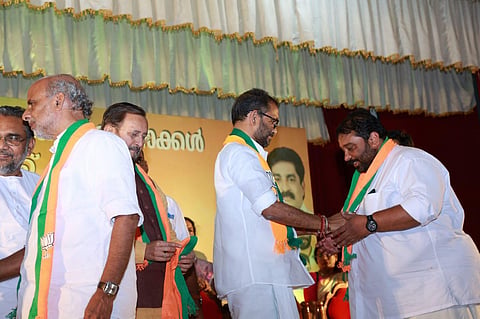 BJP Kerala president K Surendran welcomes new members to the party on Sunday. BJP's Kerala Prabhari Prakash Javadekar looks on. (Photo | Special Arrangement)