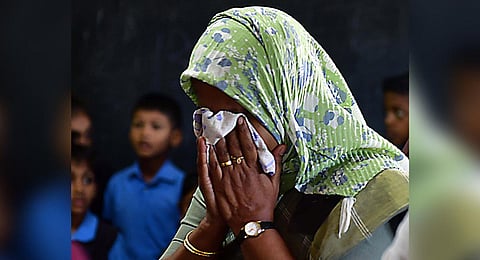 The headmistress of the school at Thaikkattukara, near Aluva, breaks down when the mortal remains of the five-year-old girl were brought there for the public to pay homage on Sunday | Express