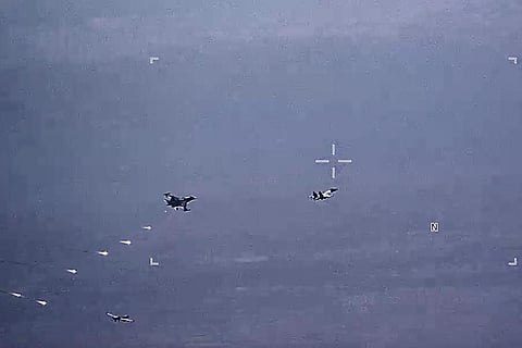 Russian military SU-34 and SU-35 aircraft release flares in the flight path of a U.S. Air Force MQ-9 Reaper drone, lower left, on Thursday, July 6, 2023, over Syria. (Photo | AP)
