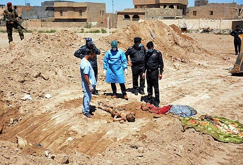 This image released by the the Mass Graves Directorate of the Kurdish Regional Government shows a human jaw bone exhumed from a mass grave containing Yazidis killed by Islamic State militants