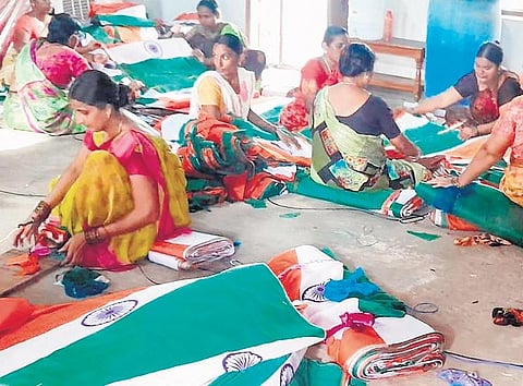 Women workers pack national flags at a textile manufacturing unit in Sircilla on Thursday. The government is paying these women Rs 12  per flag
