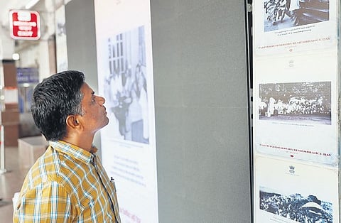 A man looks at images of the  Partition at a digital photo exhibition in Kacheguda railway station on Monday. (Photo | Sri Loganathan Velmurugan)