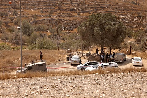 Members of Israeli security forces and emergency services stand on the site of a reported attack in southern Hebron in the occupied West Bank, on August 21, 2023. (Photo | AFP)