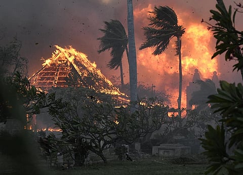 FILE - The hall of historic Waiola Church in Lahaina and nearby Lahaina Hongwanji Mission are engulfed in flames along Wainee Street, Tuesday, Aug. 8, 2023, in Lahaina, Hawaii. (Photo | AP)