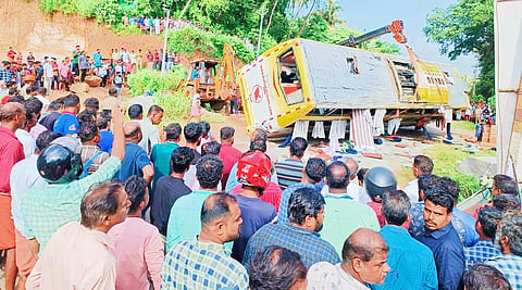 The bus involved in the accident being lifted using a crane. (Photo | Express)