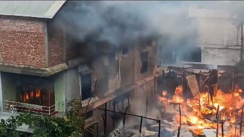 Smoke billows out of a house after unidentified miscreants burnt three houses, in Imphal, Sunday, Aug. 27, 2023. (PTI)