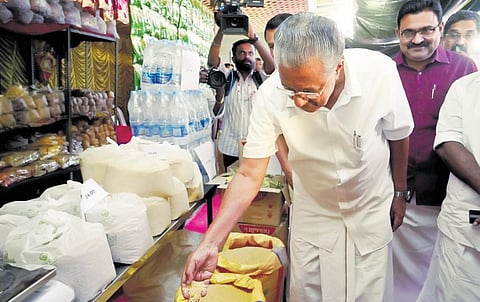 Chief Minister Pinarayi Vijayan checking the quality of grains for Onam | express