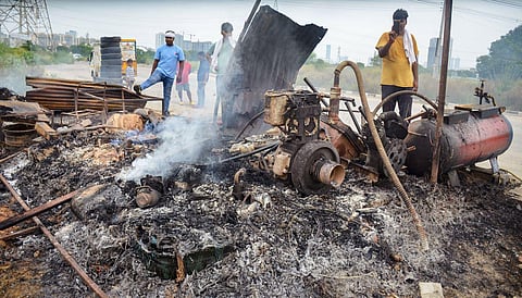 Locals look at burnt items at a shop that was set ablaze by miscreants in fresh case of communal violence after Monday's attack on a VHP procession in adjoining Nuh district, in Gurugram. (Photo | PTI