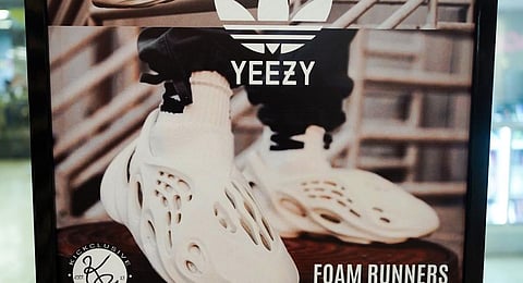 A sign advertises Yeezy shoes made by Adidas at Kickclusive, a sneaker resale store, in Paramus. (Photo | AP)