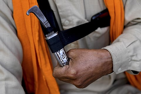 FILE - A man holds his ‘Kirpan’- a sword or a dagger carried by Sikhs as a part of their religious commandment. (Photo | AFP)
