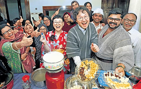 Japanese volunteers to Kerala and natives of Kuttichira in Kozhikode sharing their respective cuisines as part of a  cultural exchange programme on Friday. (Photo | Express)