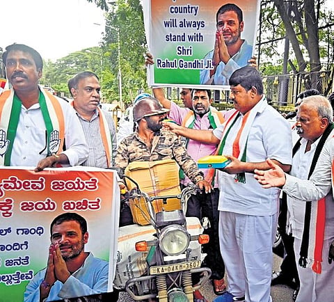 Congress supporters celebrate the Supreme Court’s order staying the conviction of Rahul Gandhi, in Bengaluru on Friday  | Shashidhar Byrappa