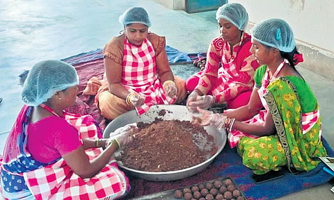 A group of women preparing ragi balls