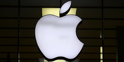 The logo of Apple is illuminated at a store. (File Photo | AP)