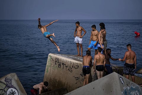 FILE - A man jumps into the sea on a breakwater in Barcelona, Spain, July  12, 2023. (Photo | AP)
