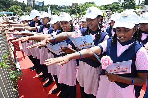 School students holding copies of the preamble to the Indian Constitution during an event at Vidhana Soudha, in Bengaluru, on Sept. 15, 2023. (Nagaraja Gadekal, EPS)