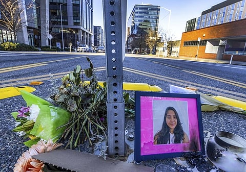 A photo of Jaahnavi Kandula is displayed at the intersection where she was killed by a Seattle Police officer driving north while responding to a nearby medical incident.