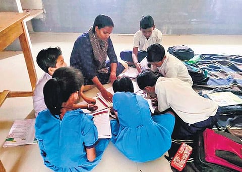 Sarpanch Lenka teaching students of Kundigaon Primary School | Express