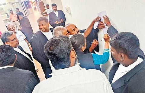 Advocates signing a petition at Tiruchy bar association on Tuesday  | Express