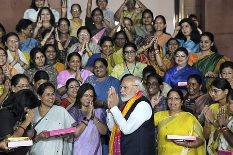 PM Modi flashes victory sign with women MPs after the passage of the Nari Shakti Vandan Adhiniyam (women's reservation bill) by the Rajya Sabha, on Sept 21, 2023. (PTI)