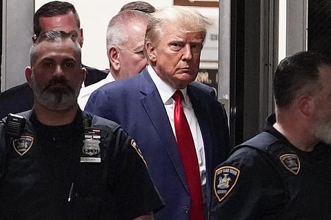 Former President Donald Trump is escorted to a courtroom, in New York. (Photo | AP)