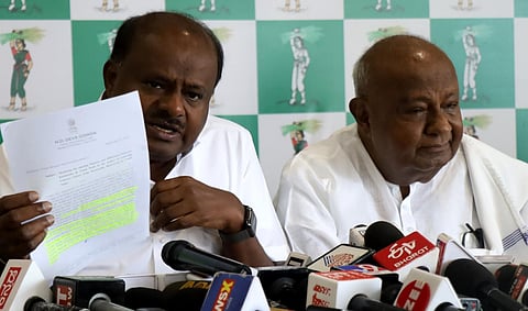 JDS supremo and former PM HD Deve Gowda and former Karnataka CM HD Kumaraswamy address the media at the party office in Bengaluru