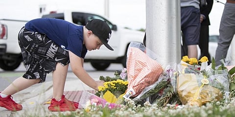A child at the scene where a man driving a pickup truck struck and killed four members of a Muslim family in Ontario, Canada. (File Photo | AFP)