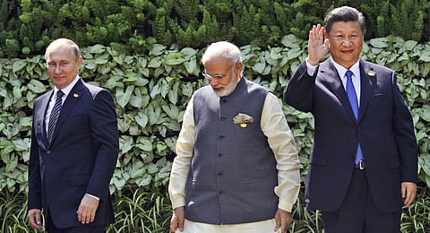 FILE- Prime Minister Narendra Modi, Russian President Vladimir Putin and Chinese President Xi Jinping stand at the start of the BRICS Summit in Goa, India, Oct. 16, 2016. (Photo | AP)