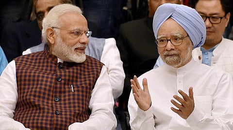 FILE - An image of former Prime Minister Manmohan Singh with PM Narendra Modi