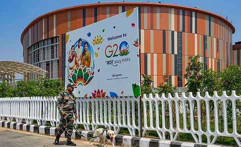 A security personnel with a sniffer dog outside Pragati Maidan ahead of the G20 Summit, in New Delhi. (Photo | PTI)