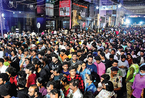 A sea of people gathers on Brigade Road  on Sunday night to usher in the New Year.  Above: Police try to control the crowd  | Shashidhar Byrappa, Allen Egenues J