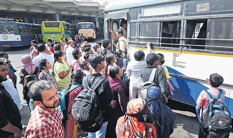 Passengers struggle to board a TSRTC bus at the MGBS in Hyderabad on Thursday. The rush of passengers has increased as Sankranti approaches | Vinay Madapu