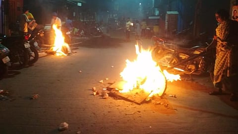 People burn waste and unused clothes during Bhogi ahead of Pongal. 