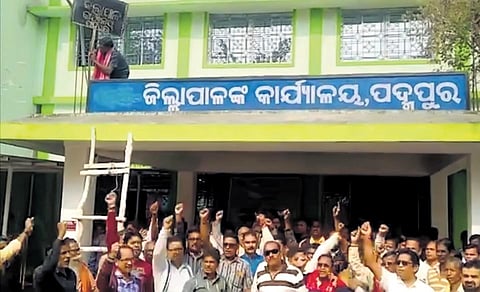 Agitators erasing the ‘sub’ from the signage of sub-collector’s office in Padampur | Express
