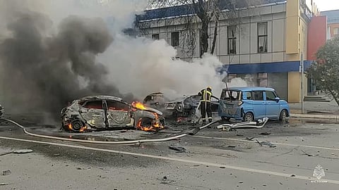 Firefighters extinguish burning cars after shelling in Belgorod, Russia. (Photo | AP)