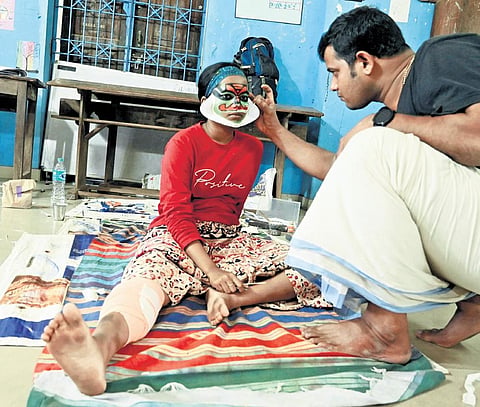 Hridya Haseen, the kathakali contestant with burns, receiving a final touch-up before her performance | Vincent Pulickal